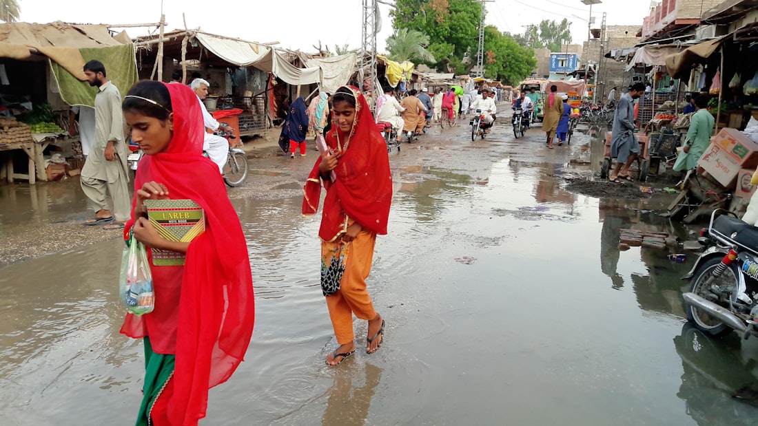 A woman wading through floodwater